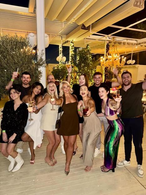Group of people celebrating with drinks.
