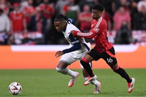 Destiny Udogie of Tottenham competing for the ball with Amad Diallo of Manchester United.