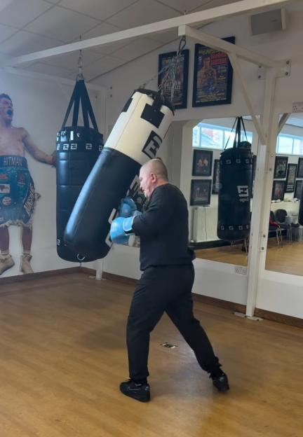 Ricky Hatton boxing a heavy bag.