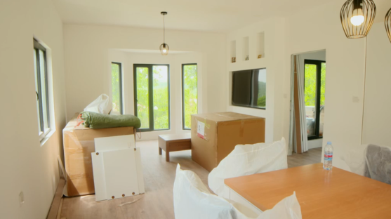 Living room with furniture still in boxes.