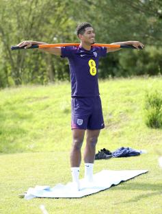 Jude Bellingham stretching during an England team training session.