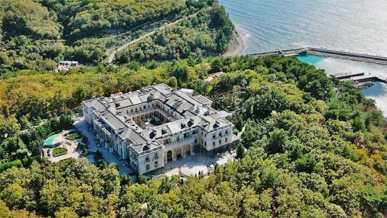 an aerial view of a large building in the middle of a forest
