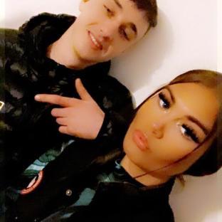 Photo of a young man and woman posing together.