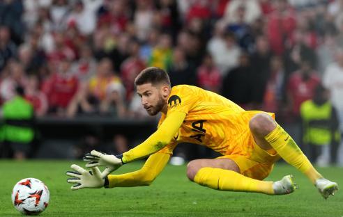 Guglielmo Vicario making a save during a soccer match.