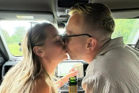 Dani Dyer clutches a bottle of champagne as she kisses husband Jarrod Bowen in unseen wedding day snaps