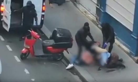 Footage of three masked men forcing a woman into a van.