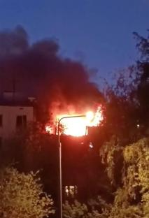Building engulfed in flames at night.