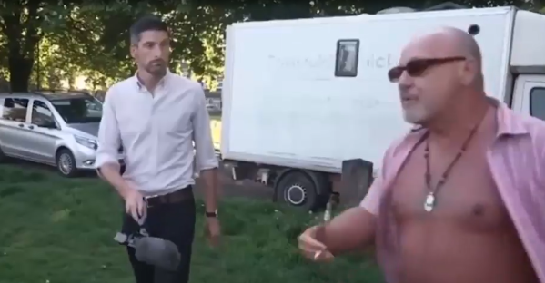 Watch moment furious man clashes with local and interrupts BBC news report