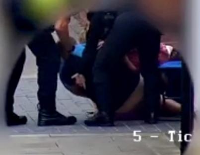 Photo of a shop owner collapsing after being injected with a drug by an anaesthetic nurse.