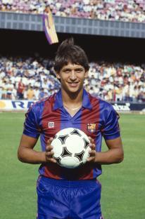 Gary Lineker in an FC Barcelona uniform holding a soccer ball.