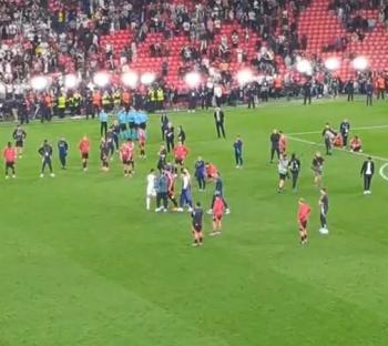 Soccer players on the field after a game.