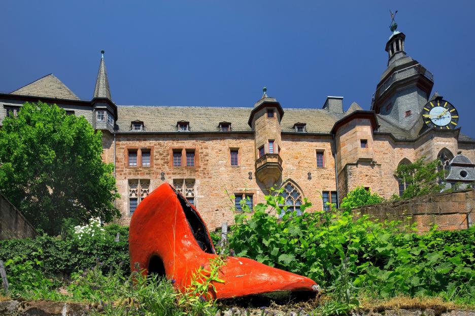 Giant red glass slipper in front of Marburg Castle, Germany.