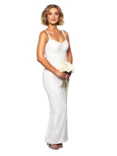 Woman in a white sequined gown holding a bouquet of white roses.