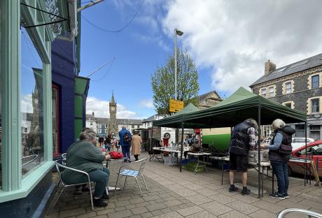 Tourists at a market in Machynlleth, Wales.