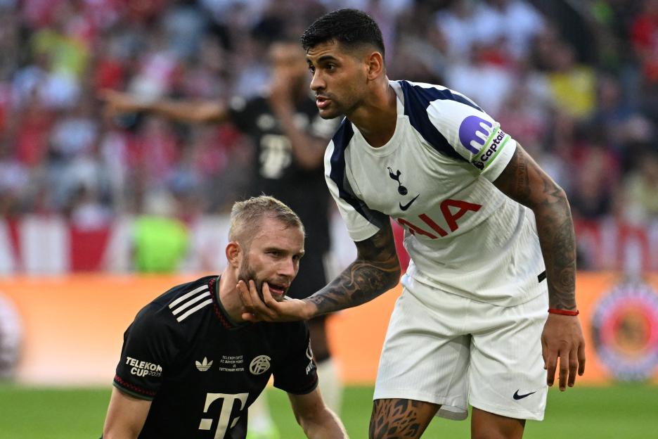 Cristian Romero of Tottenham Hotspur and Konrad Laimer of Bayern Munich during a soccer match.