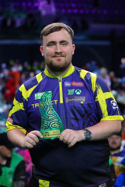 Luke Littler holding the 2025 Australian Darts Masters champion trophy.
