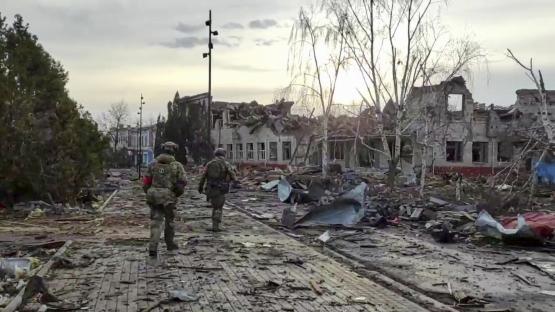 Russian soldiers patrolling a war-damaged area in Sudzha, Kursk region.