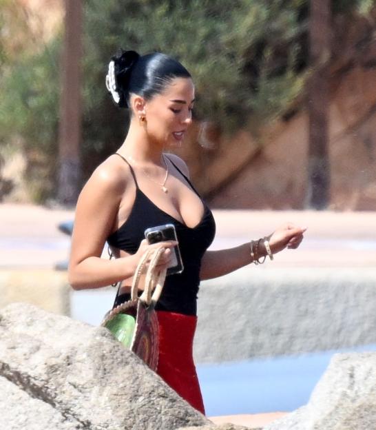Ashlyn Castro, girlfriend of Jude Bellingham, walking near rocks.