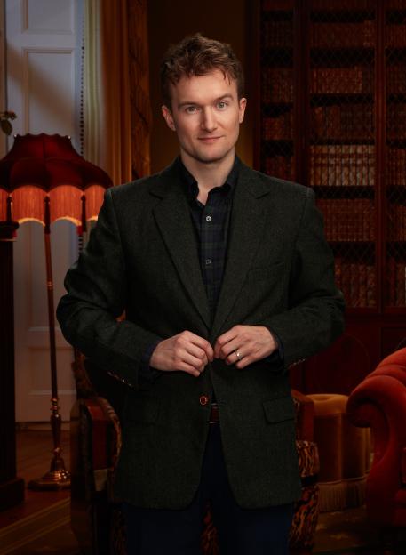 Portrait of a man in a dark blazer.