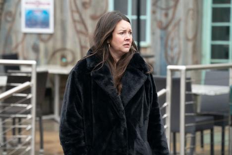 Stacey Slater from EastEnders in a black coat.