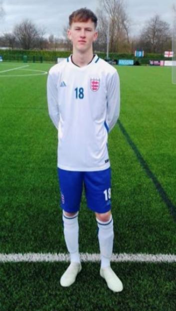 Sam Harding in a white soccer uniform with the number 18 and an England crest.