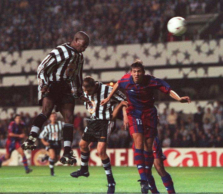Faustino Asprilla of Newcastle United heading the ball in a football match against Barcelona.
