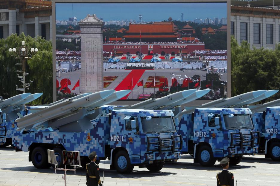 Military vehicles carrying YJ anti-ship cruise missiles at a parade.