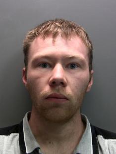 Mugshot of Adam Carruthers.