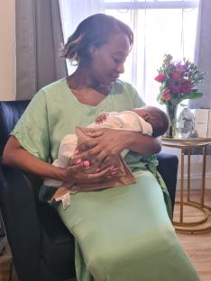 Woman holding her newborn baby.