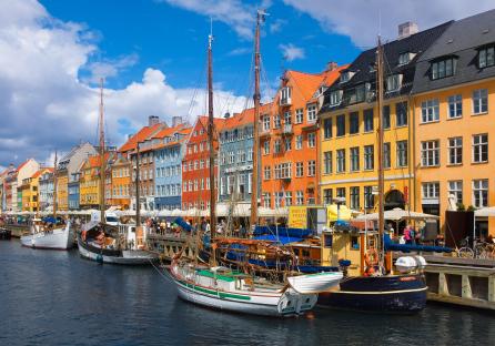Nyhavn harbor in Copenhagen with colorful buildings and boats.