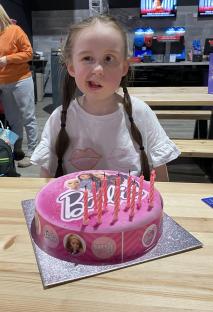 Girl with Barbie birthday cake.