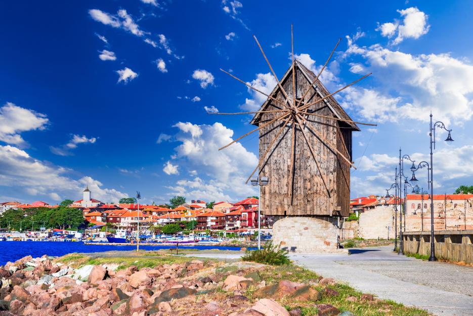 Old wooden windmill in Nesebar, Bulgaria, overlooking the sea.
