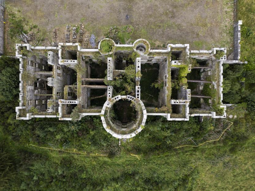 Aerial view of overgrown Dalquharran Castle ruins.
