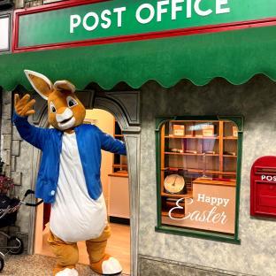Rabbit costume in a children's play village post office.