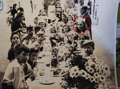 Black and white photo of children at a VE Day street party.