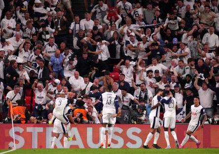 Tottenham Hotspur players celebrating a goal with jubilant fans.