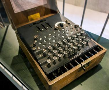 WWII German Enigma machine in wooden box.