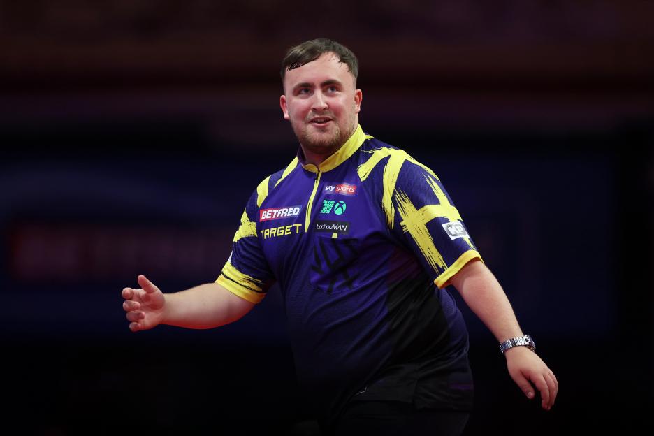 Luke Littler of England reacting during a darts match.