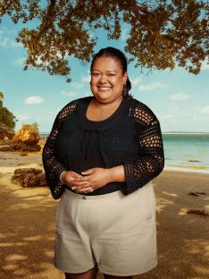 Woman smiling on a beach.