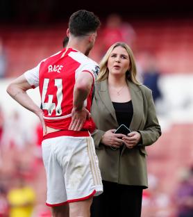 Declan Rice and his girlfriend at a soccer stadium.
