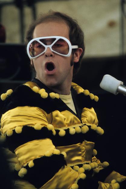 Elton John performing at an outdoor concert.
