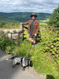 Man with dog walking in countryside.