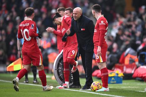 Liverpool manager Arne Slot speaks with players during a match.