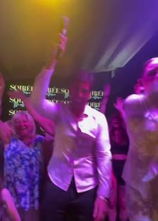James Argent singing and dancing in a nightclub.