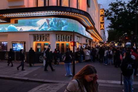 Le Grand Rex theatre in Paris with a crowd waiting for a documentary preview.