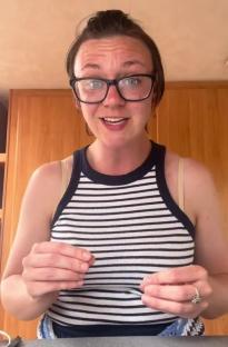 a woman wearing glasses and a striped tank top