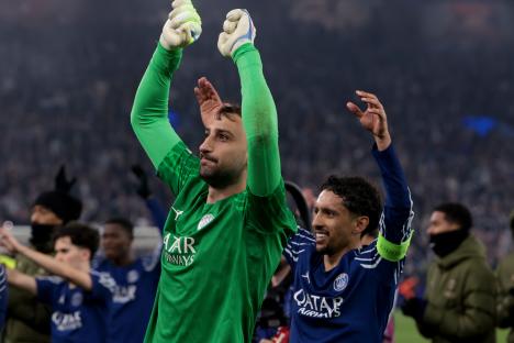 Gianluigi Donnarumma and Marquinhos of PSG celebrating a victory.
