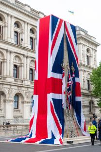 Union Jack flags draped over a monument in London.