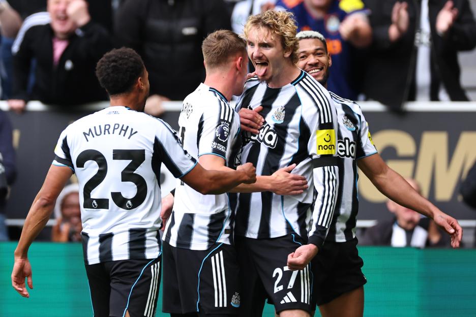 Newcastle United player Nick Woltemade celebrates after scoring a goal, with teammates around him.