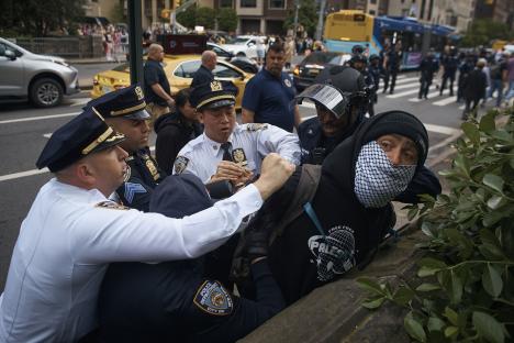 Police officers arresting a pro-Palestinian protester.